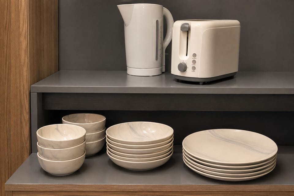 Well-stocked kitchenette with kettle, toaster, and modern dishware