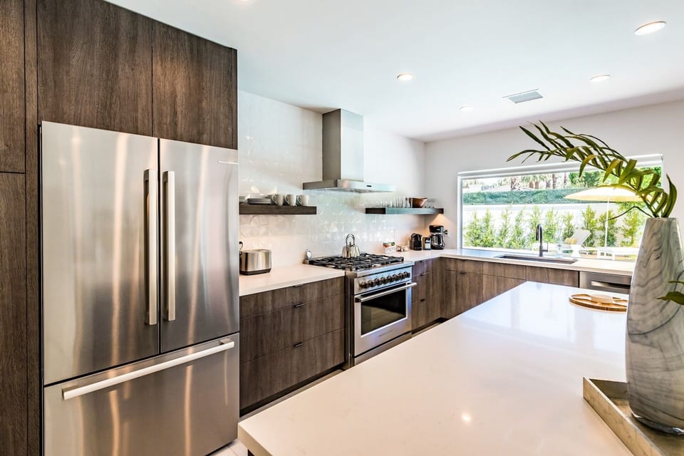 Step into your sleek, modern kitchen where sunlight pours in and every meal feels inspired. Gleaming countertops, quality appliances, and a serene garden view make cooking here pure joy.