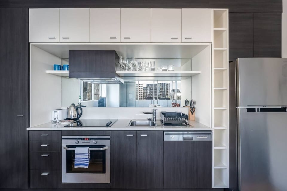 Cook with ease in the kitchen, where modern appliances and a clean, open layout make everything feel simple, with city views reflected through the space.
