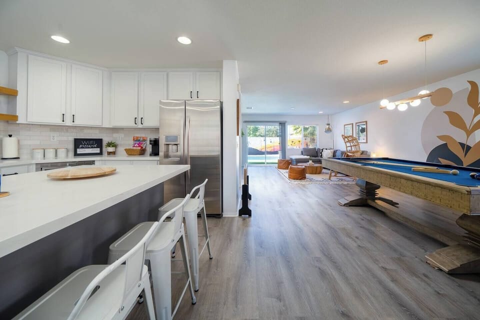 Open-concept kitchen with island seating flows into the game room and living space—perfect for families and groups!