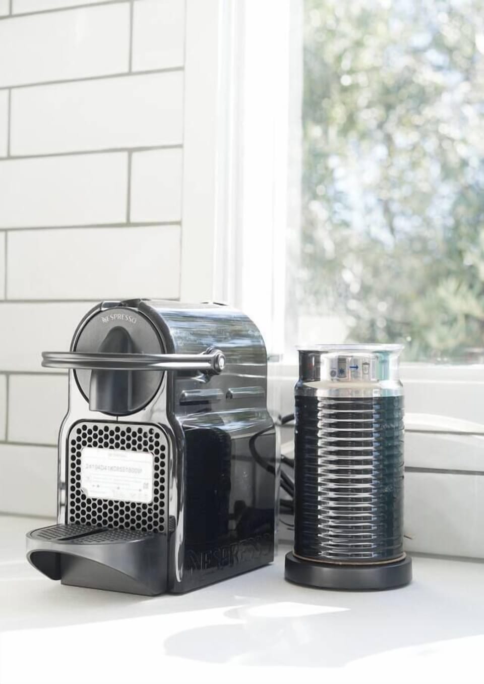 Start your day right with barista-style coffee from the Nespresso machine, nestled by a window framing calming garden views.