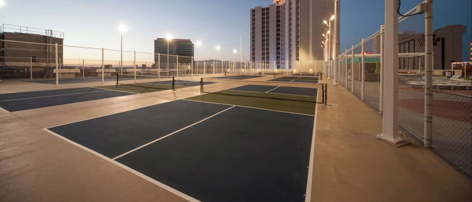Challenge friends to sunset matches on rooftop pickleball courts.