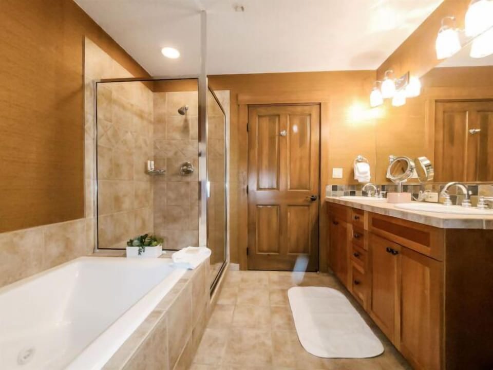Spa-like bathroom with soaking tub, glass shower, and double vanity