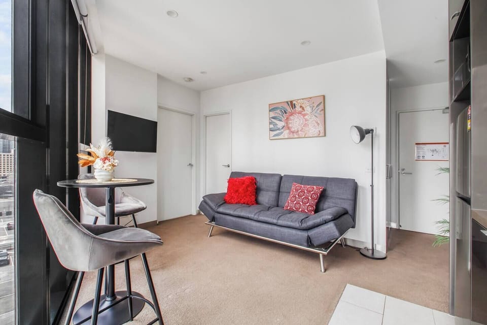 The open-plan layout makes smart use of space, where the living area flows into a casual dining nook and wall-mounted TV zone.