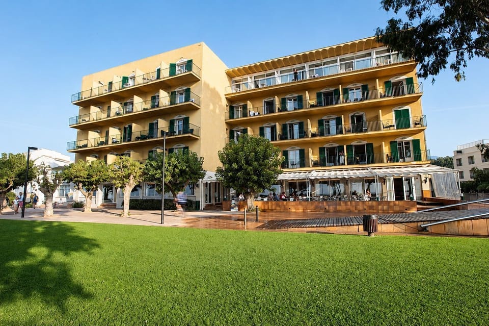 Hotel exterior with beachfront promenade.