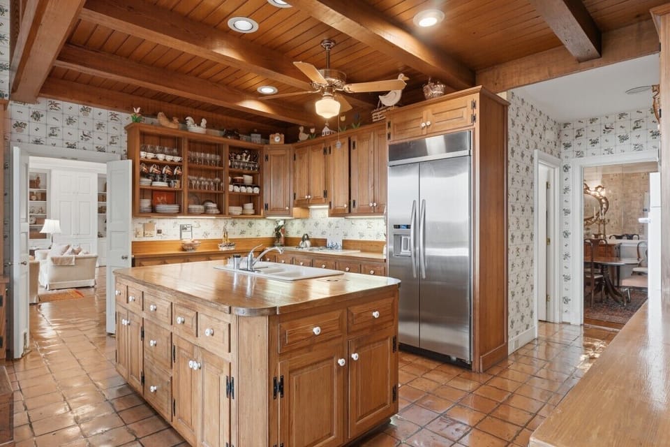 Kitchen | Full-Size Refrigerator | Ceiling Fan & Wood Cabinets