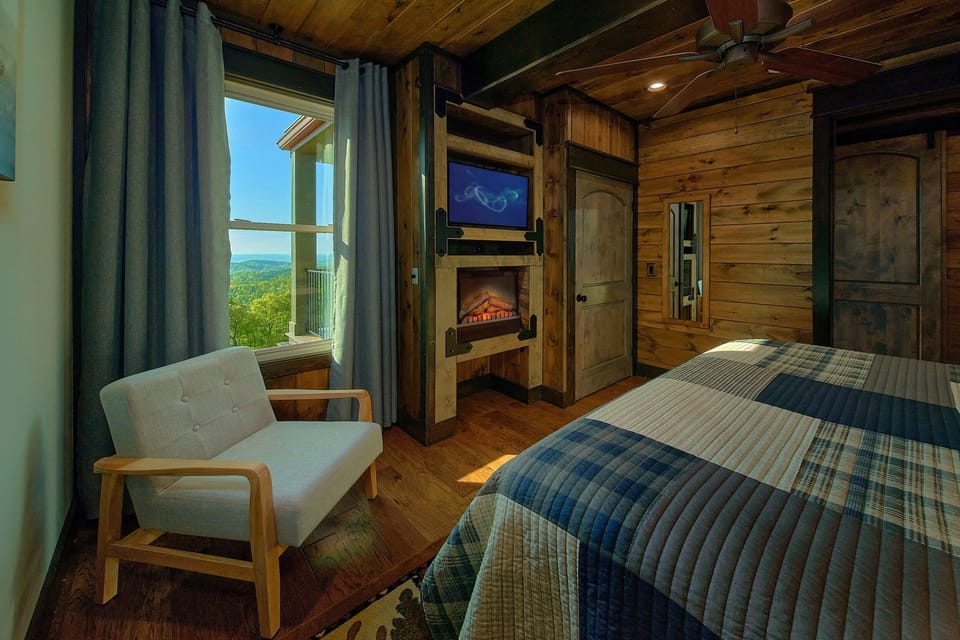 Bedroom with fireplace and TV in cabin rental