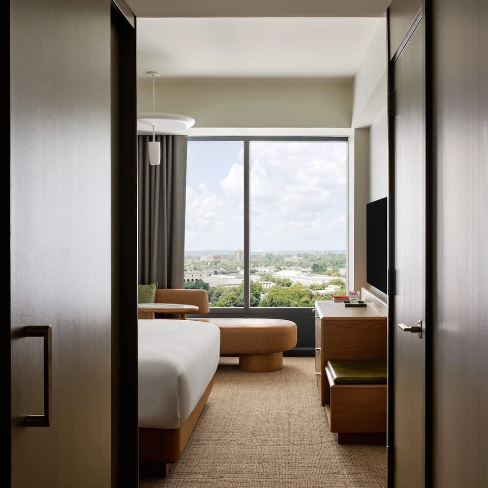 Walk into a bright bedroom framed by panoramic windows.