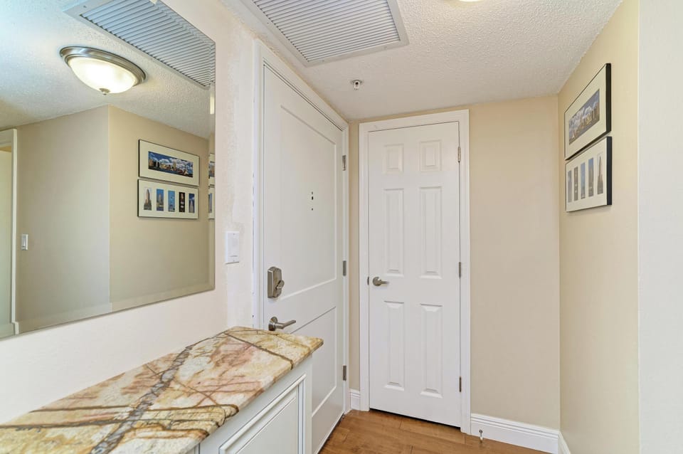 Bright, stylish entryway with mirror, art, and a welcoming feel