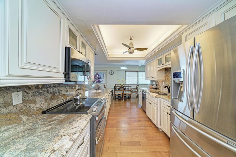Bright gourmet kitchen with granite counters and stainless appliances