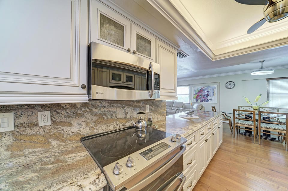Bright gourmet kitchen with granite counters and spacious open layout