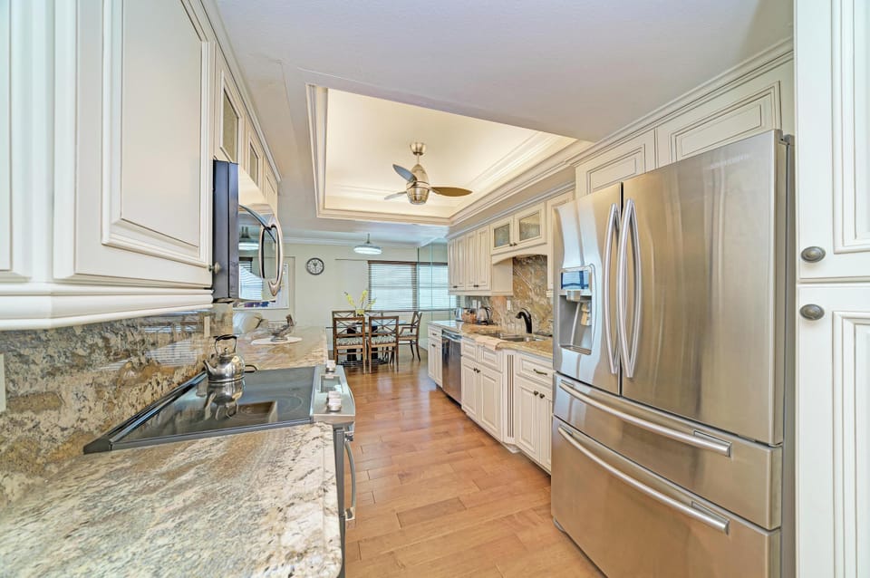 Bright gourmet kitchen with granite counters and stainless appliances
