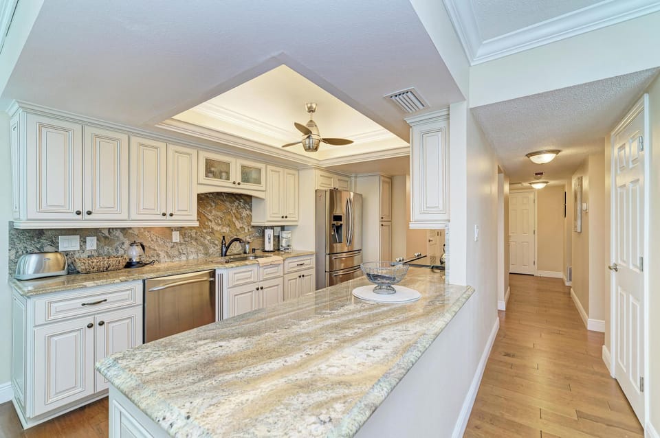 Bright gourmet kitchen with granite counters and stainless appliances