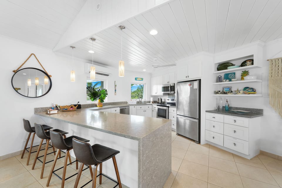 Luxurious modern kitchen finished in quartz and stainless steel.