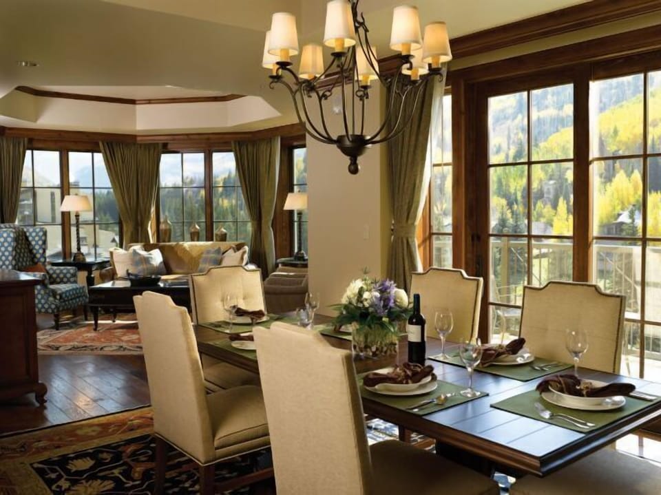 Elegant mountain-view dining and living space with floor-to-ceiling windows