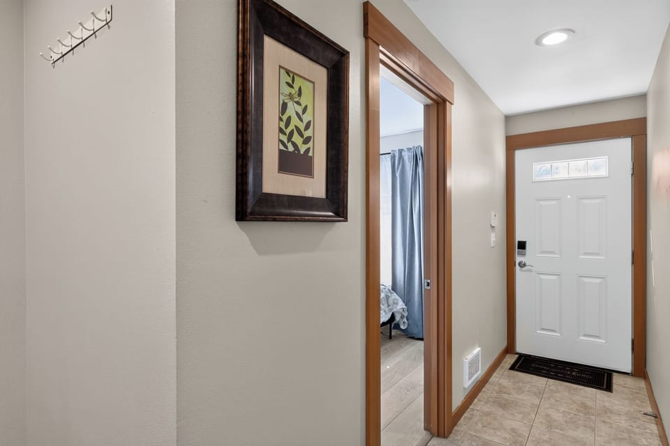 Bright, welcoming entryway with tile floors and warm wood details
