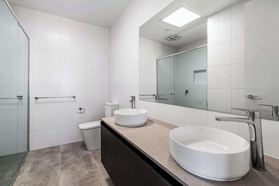 Master ensuite with a dual vanity and walk-in shower