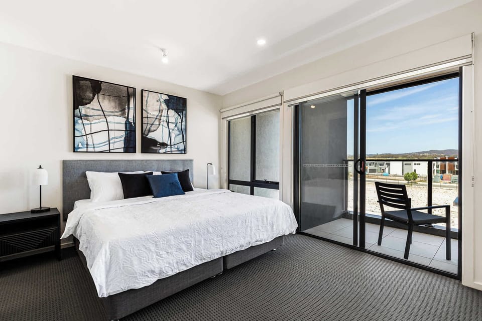 Floor-to-ceiling master retreat with private balcony — King bed, split-system heating and cooling