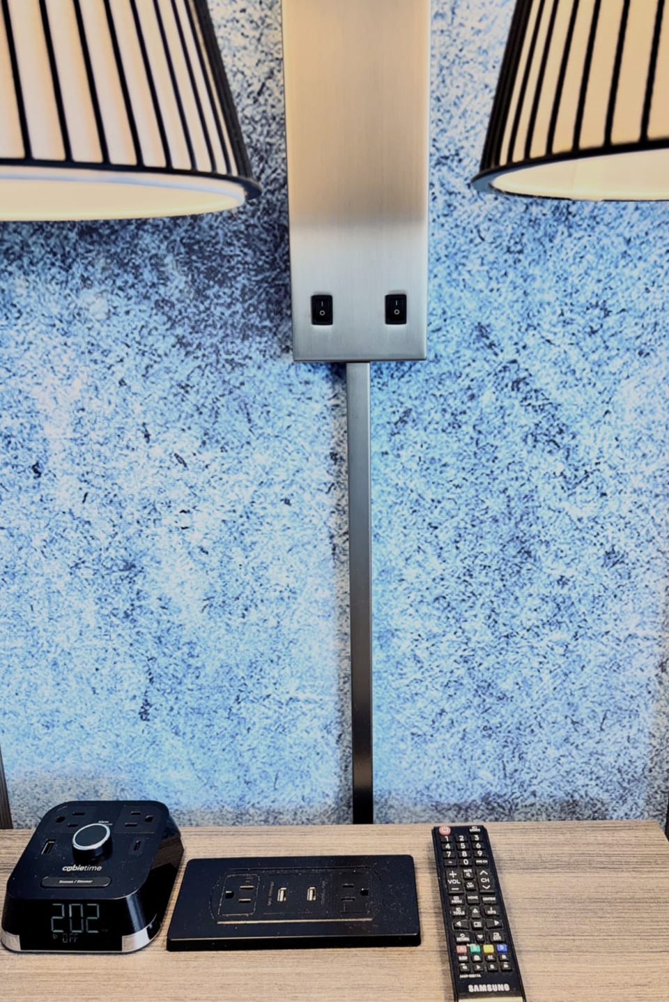 Bedside charging station with multiple outlets and USB ports.