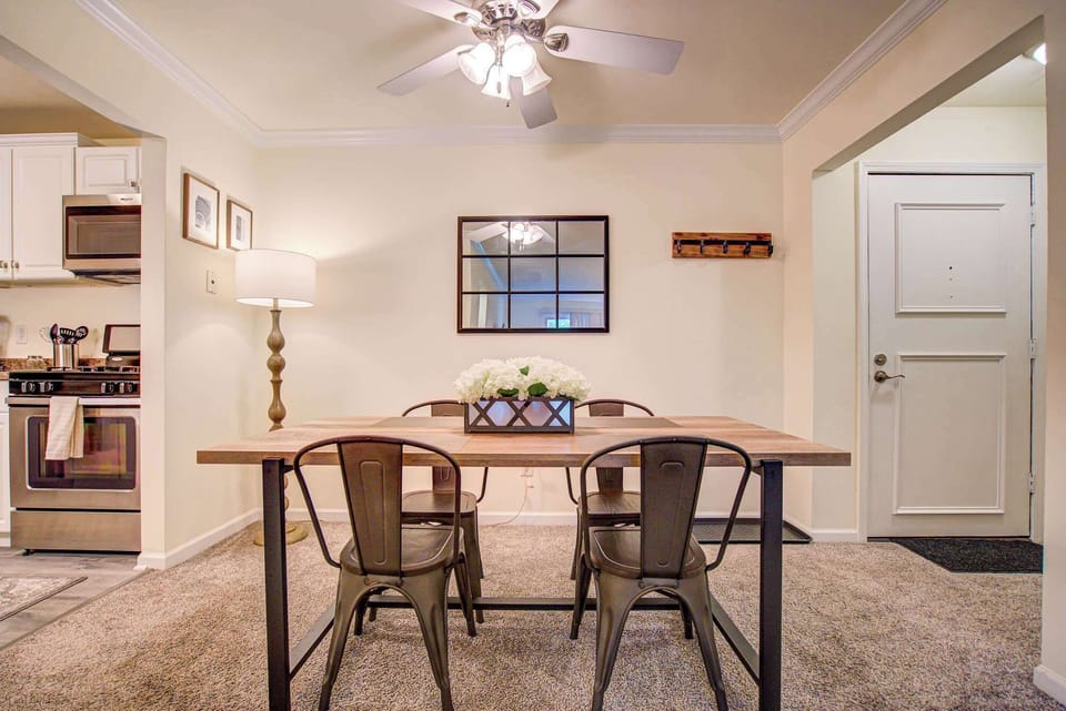 Charming dining area with modern metal chairs, a warm wood table, and soft lighting—perfect for cozy meals or casual gatherings.