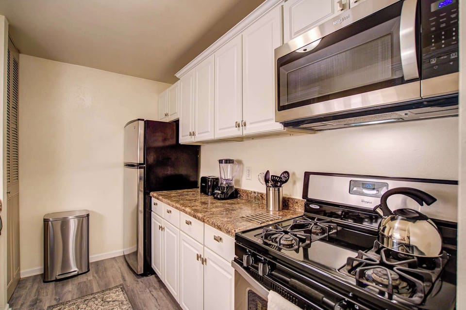 Fully equipped kitchen with stainless steel appliances, granite-style countertops, and all essentials for a convenient stay.