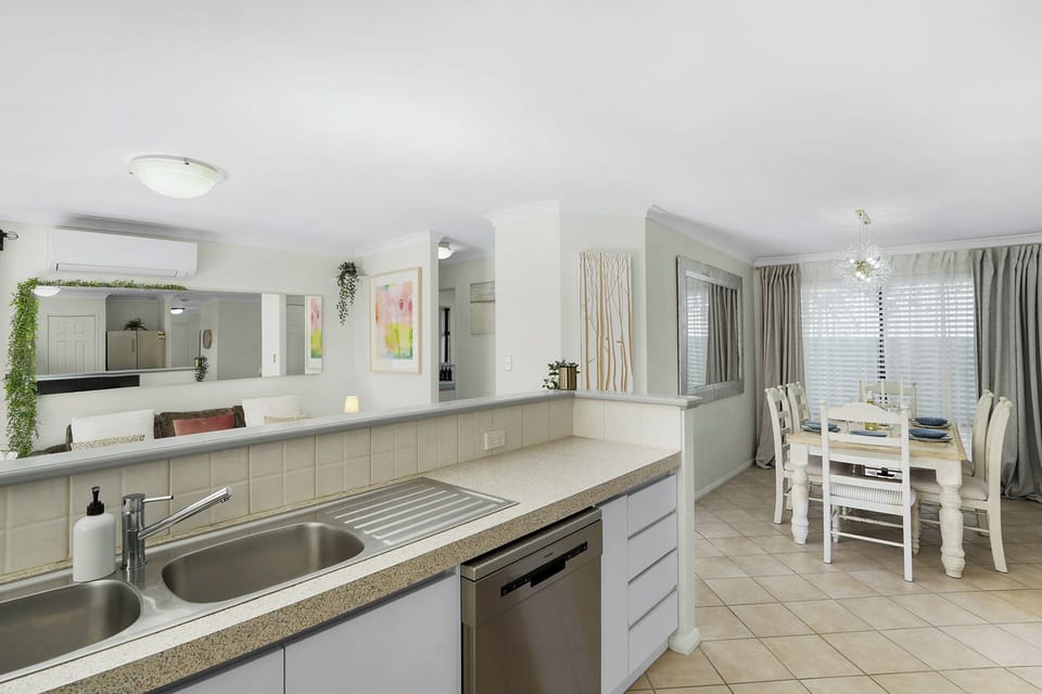 Kitchen area with the dishwasher and overview of the dining area  