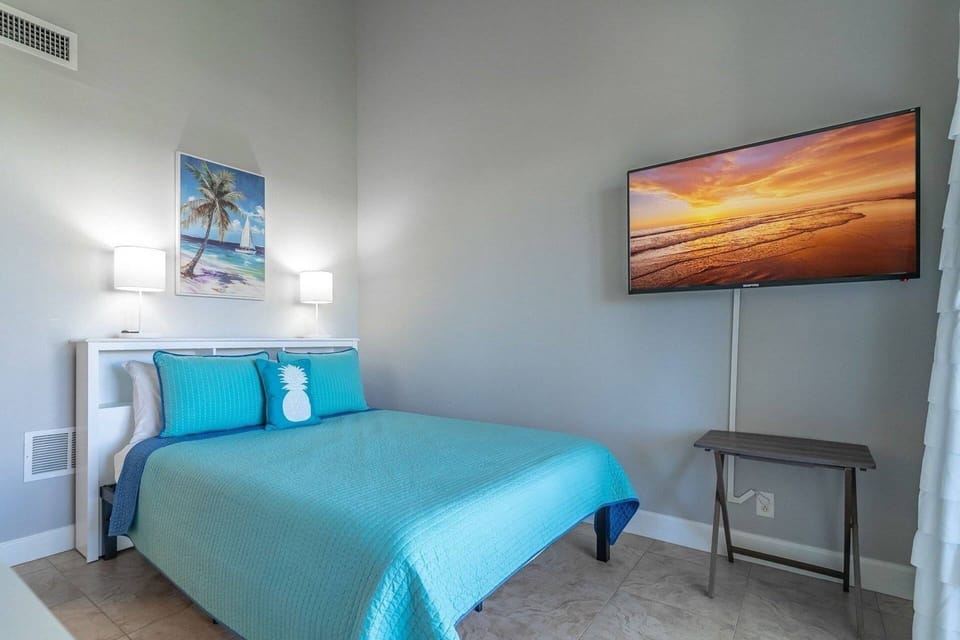Third Floor Master B with Queen Sized Bed, Vaulted Ceiling, Wall Mounted TV, Private Balcony and Private Full Bathroom