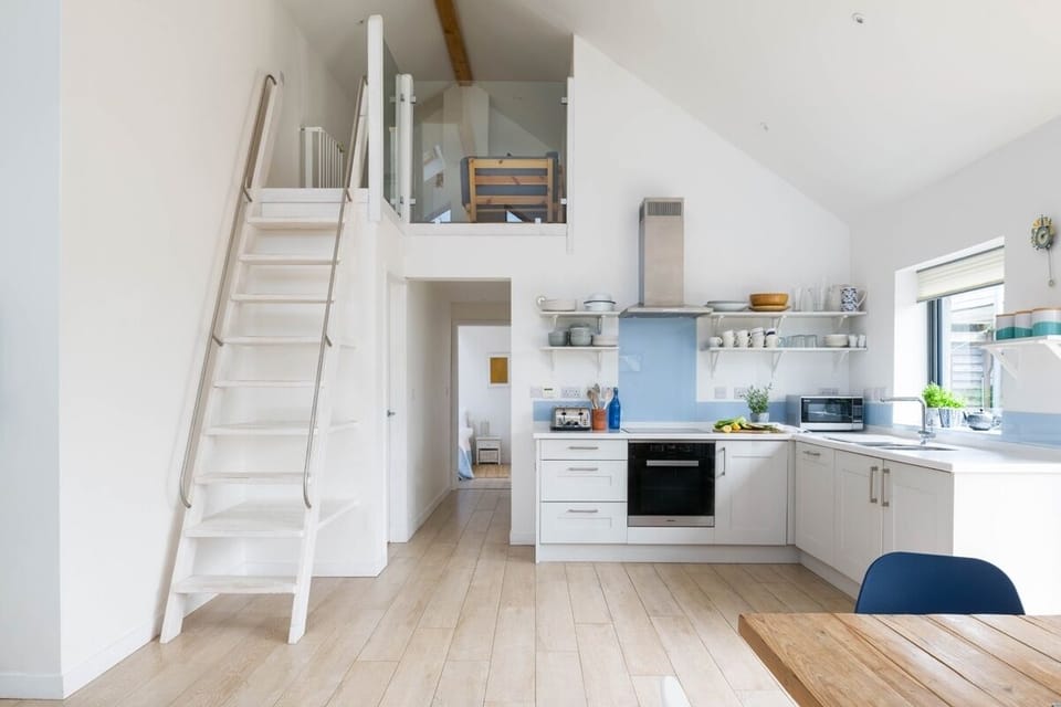 Kitchen and stairs interior at An Mordros Gwithian beach house