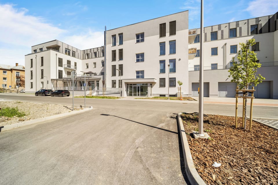 Modern apartment exterior with easy access, fresh landscaping, and sleek design