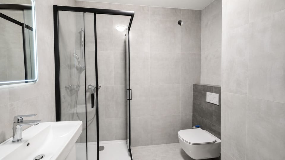 Modern spa-style bathroom with glass shower and sleek finishes