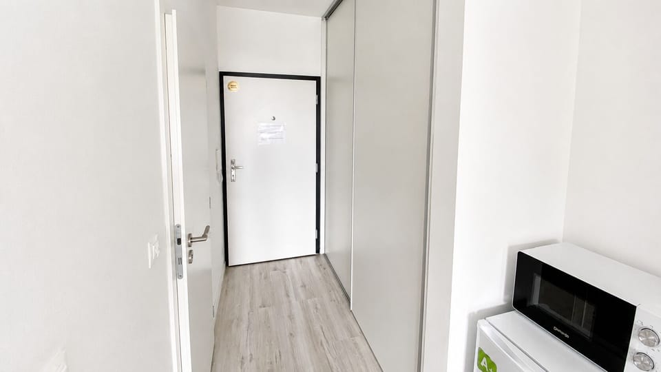 Bright modern entryway with built-in storage and handy kitchenette touches