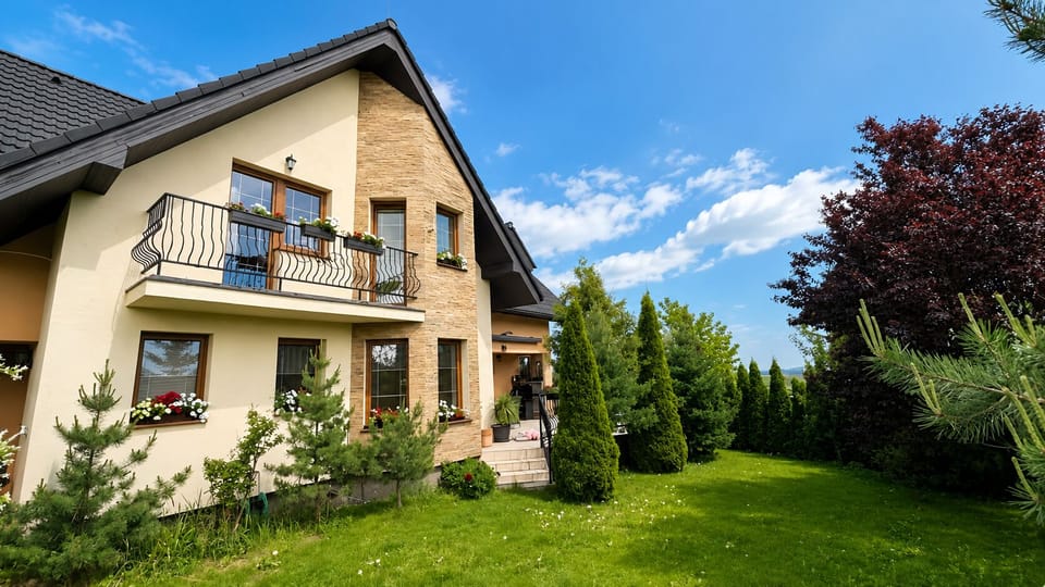 Charming home with balcony, lush garden, and private green yard