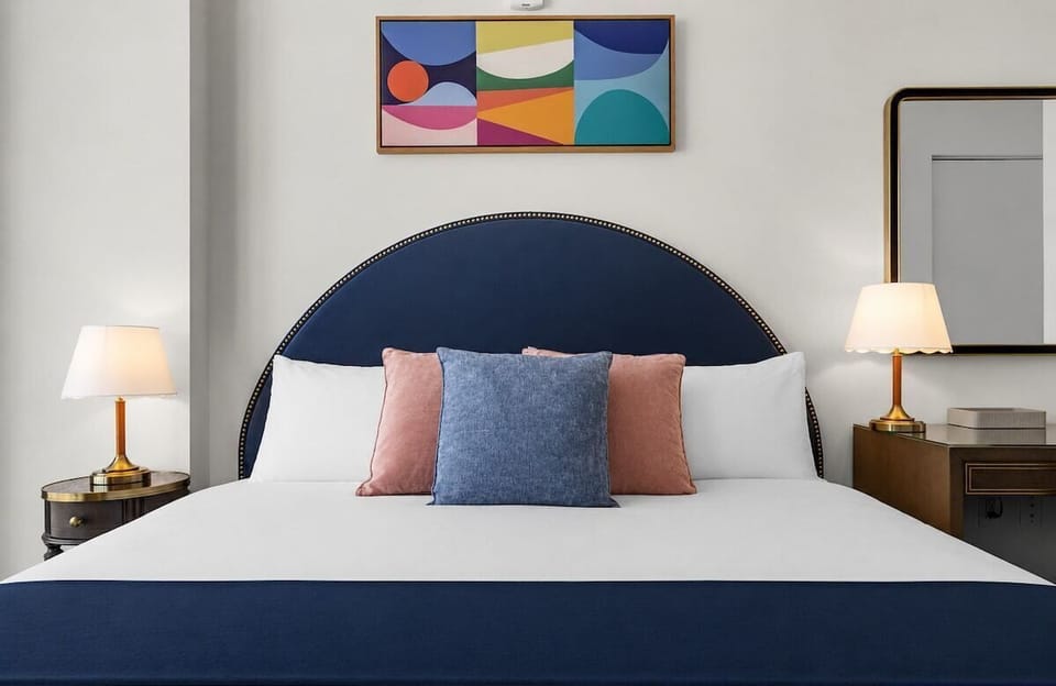 Sink into luxury! This premium King bed is outfitted with high-end linens, plush pillows, and a stylish navy headboard. The perfect spot to recharge in ultimate comfort after a vibrant day in Wynwood.
