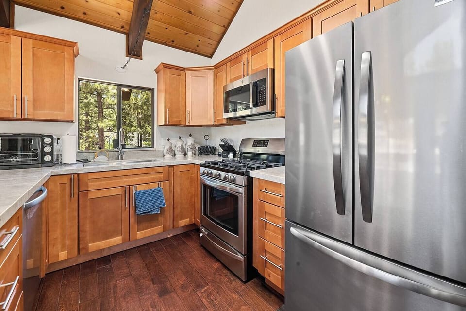 The fully equipped kitchen with quartzite countertops is ready for your MasterChef skills.
