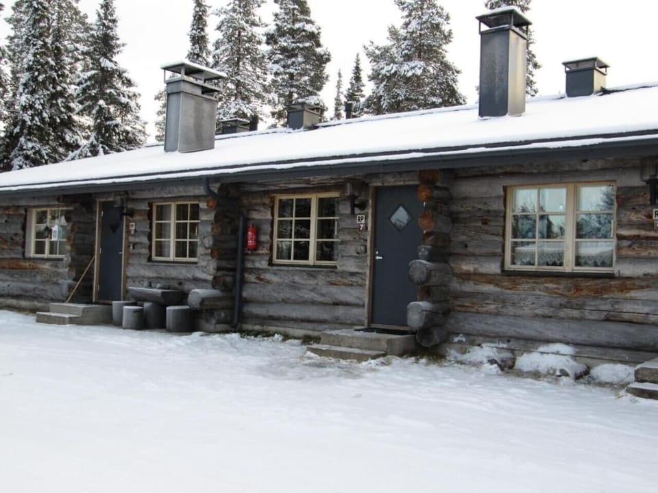 Exterior of the property covered in snow, seen from a different angle.
