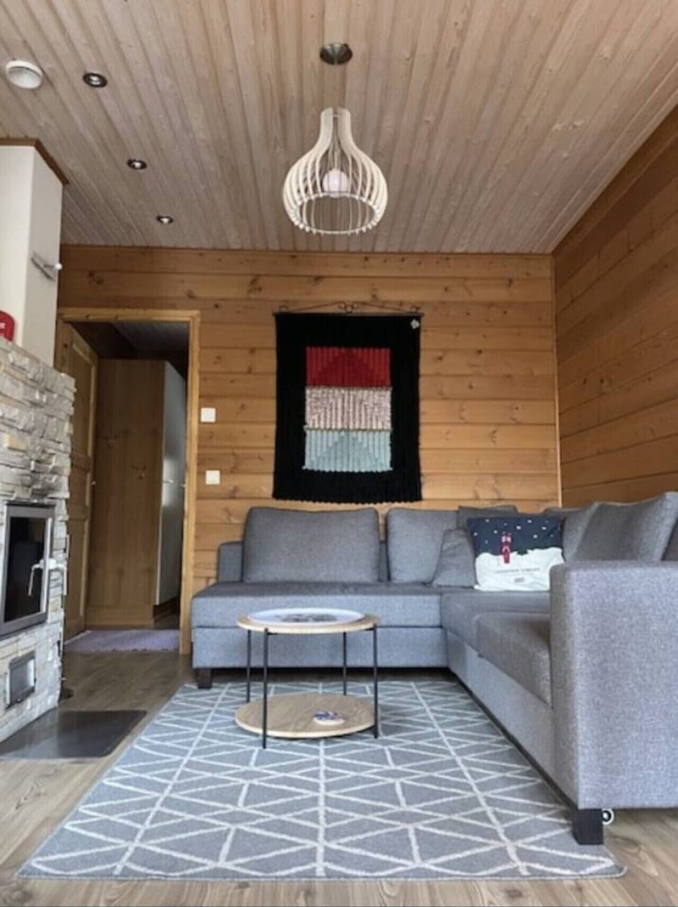 Spacious living area with a corner sofa and a soft rug for relaxing after a day outdoors.