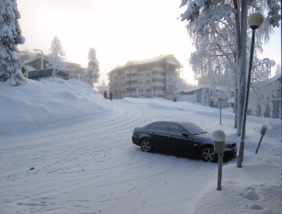Outdoor parking space beside the building with a car heating post available.