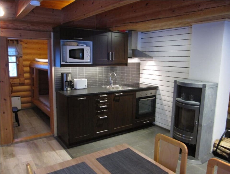 Fully equipped kitchen with an oven, microwave, kettle and coffee maker.