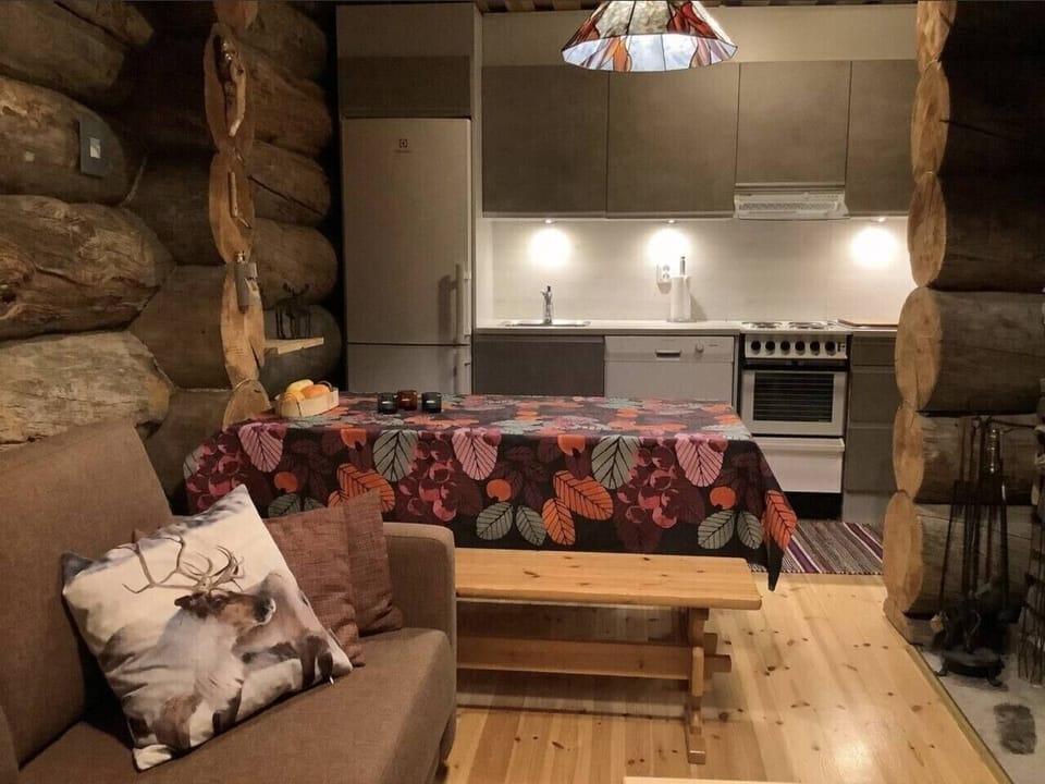 Open-plan kitchen and living area with a dining table and seating.