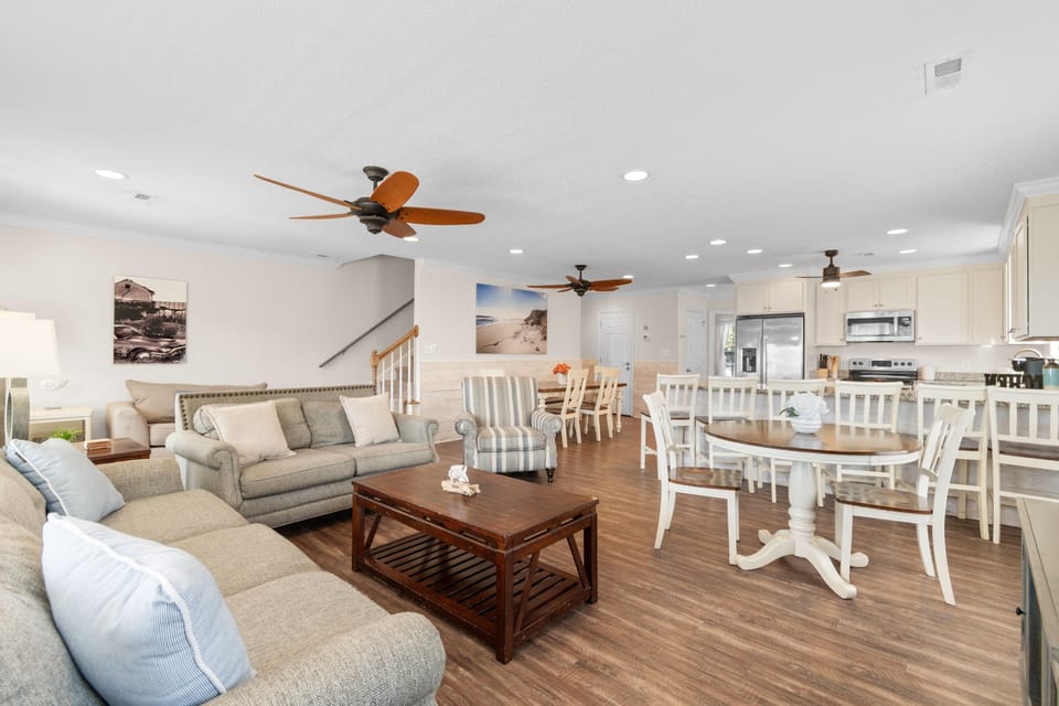 Relax in your spacious open-concept living area where coastal comfort meets modern convenience, perfect for gathering with loved ones.