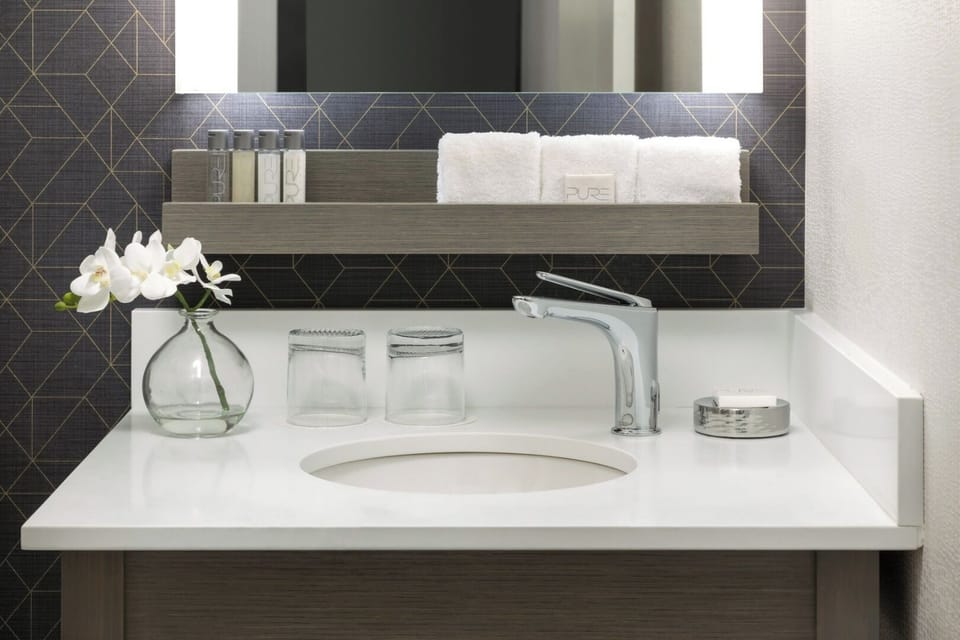 Refresh at a sleek vanity with spa-like lighting.