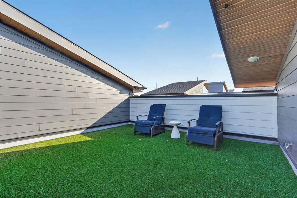 Private rooftop-style patio with turf and cozy lounge seating