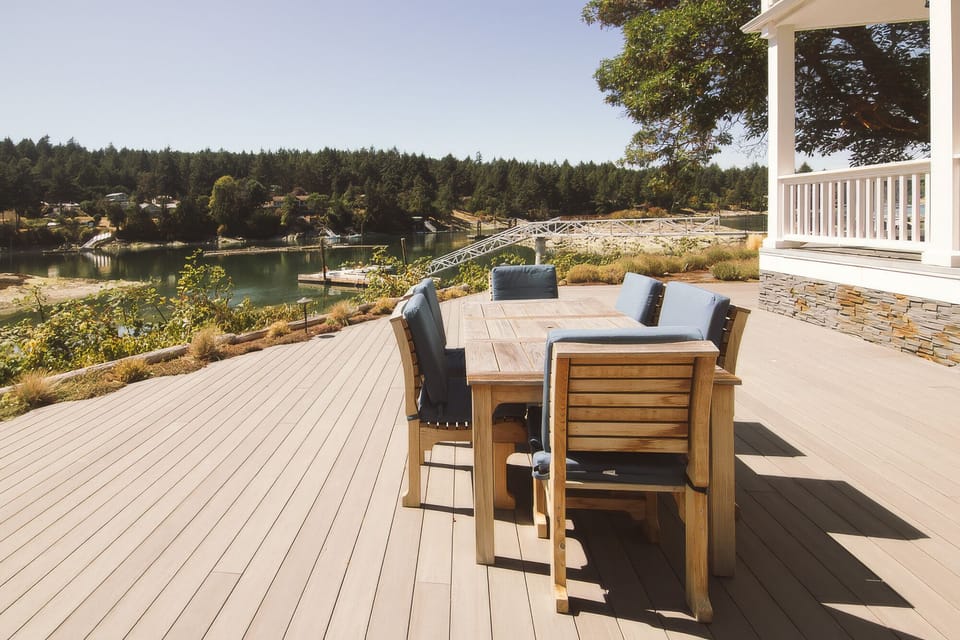 Spacious waterfront deck with outdoor dining and peaceful marina views