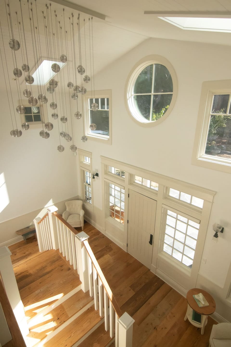 Sun-filled grand entry with statement chandelier and soaring ceilings