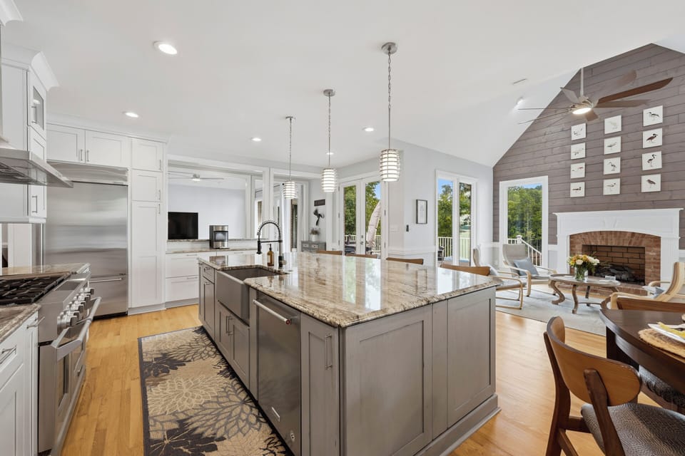 A well-equipped kitchen combines generous counter space, a farmhouse sink, and a professional-style range, with lake views just beyond the windows.