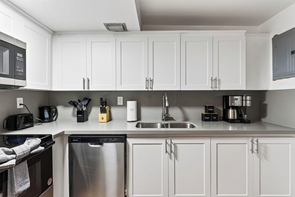 A streamlined kitchen keeps meal prep simple, with full-size appliances, generous cabinet storage, and the dining area just steps away.
