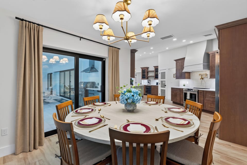 Close-up of the formal dining setup showing details of the light fixture and decor.