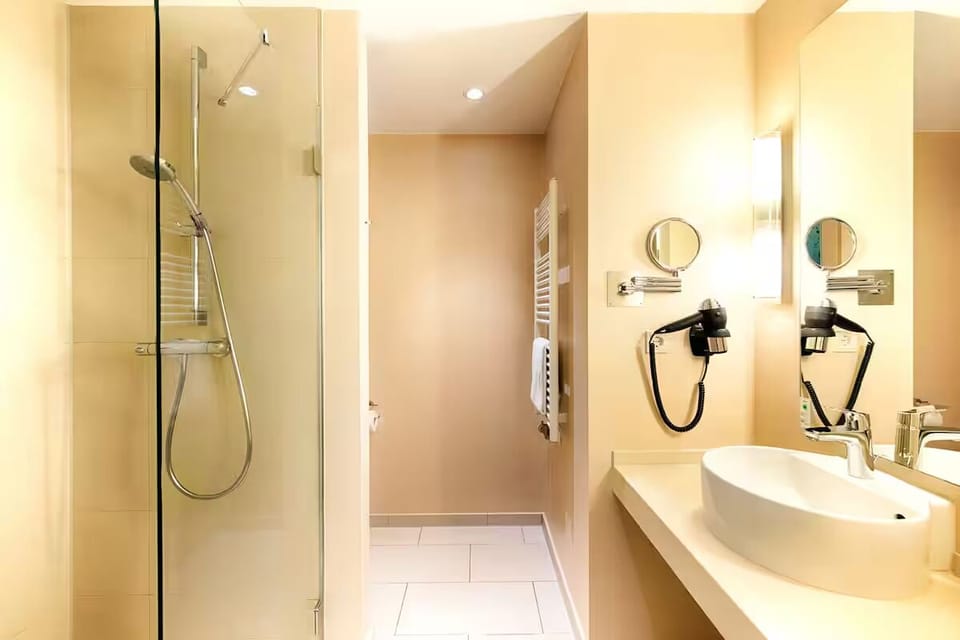 Refresh in a spotless walk-in shower with bright vanity.