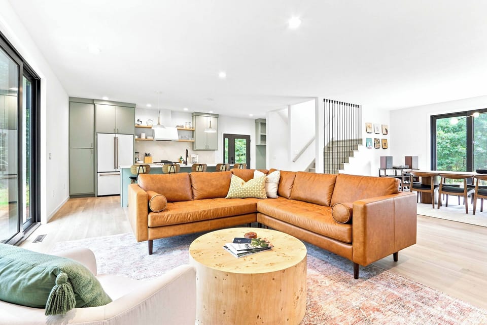 Unwind on the mid-century cognac leather couch, perfect for movie nights or post-adventure relaxation.