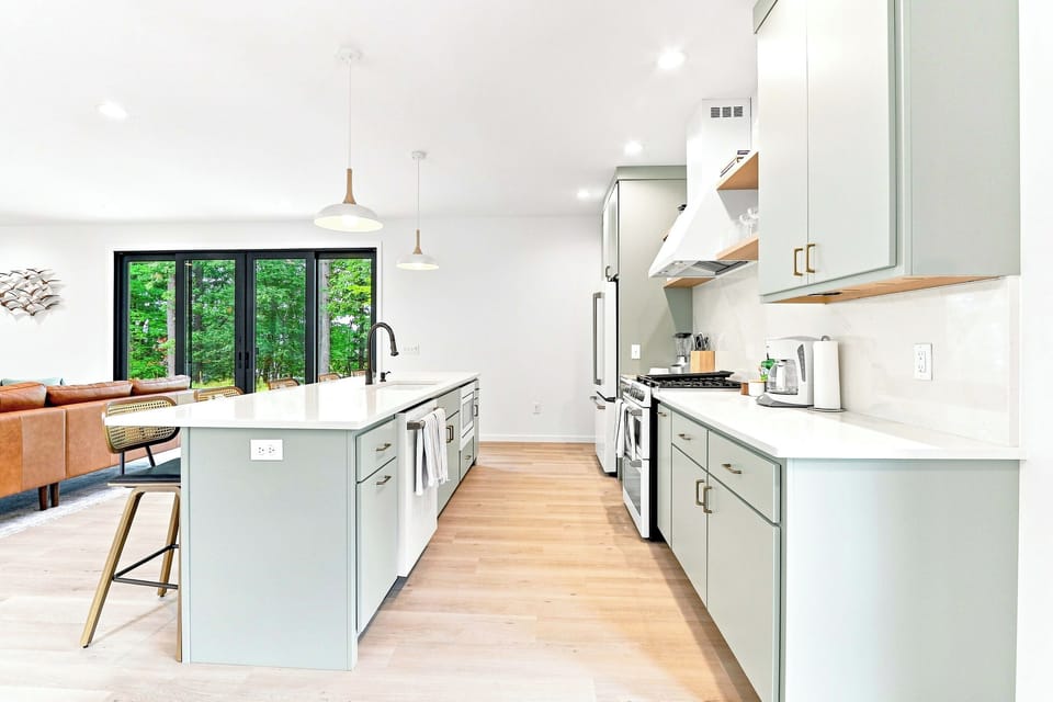 Experience effortless flow in this airy culinary space designed to bring everyone together. Flooded with natural light, this bright layout keeps cooks connected to both the living area and the scenic beauty waiting just beyond the glass.